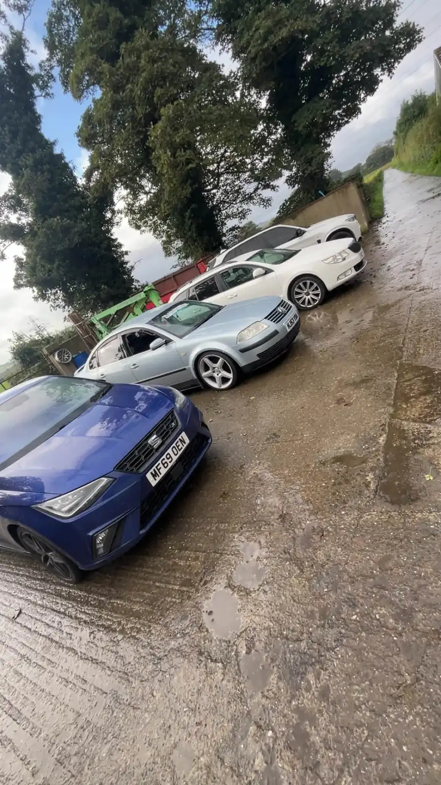 Customers' cars parked on the concrete yard outside the unit
